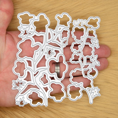 Layered floral stem cutting dies shown in hand for size reference and card making scale