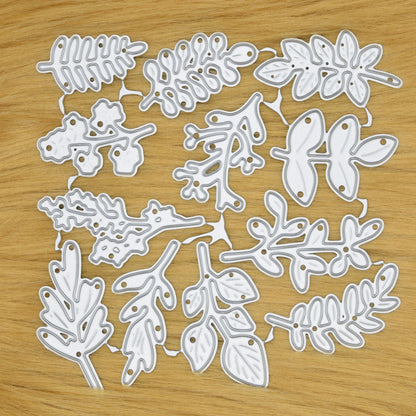 Connected set of 12 leaf and foliage metal cutting dies displayed on a light tan faux fur background