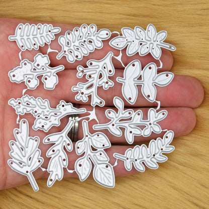 Leaf and foliage metal cutting die set held in hand to show the size and variety of botanical sprig designs