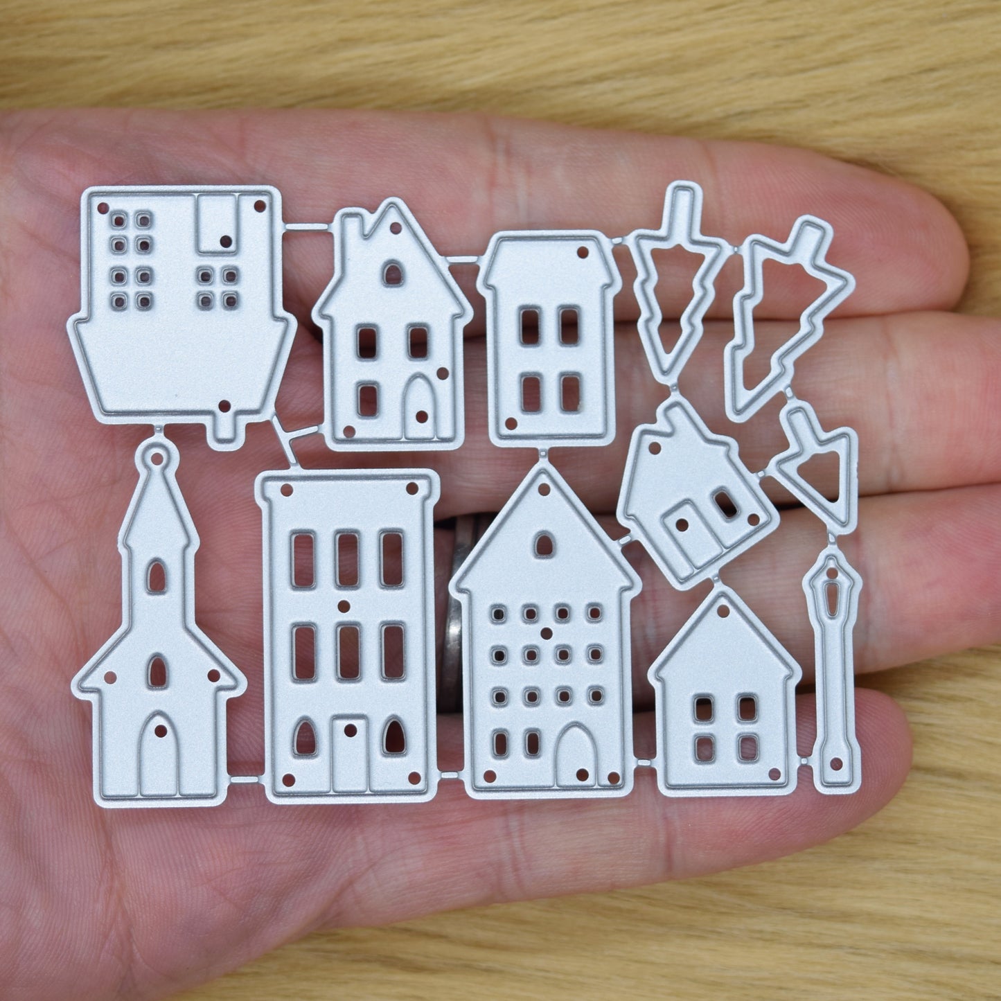 Small house metal cutting dies held in hand for size reference