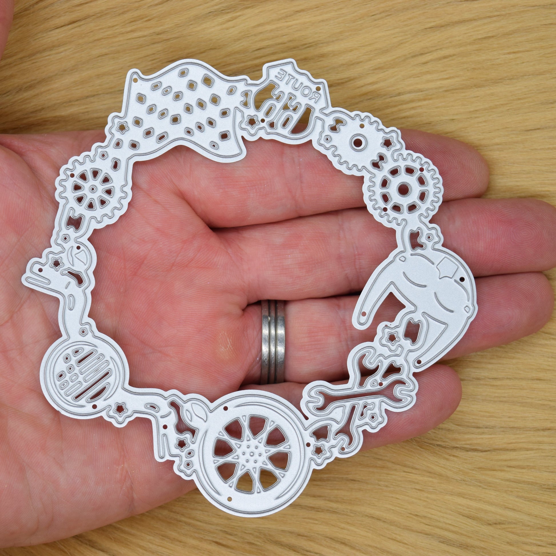 Motorbike frame metal cutting die held in hand showing size