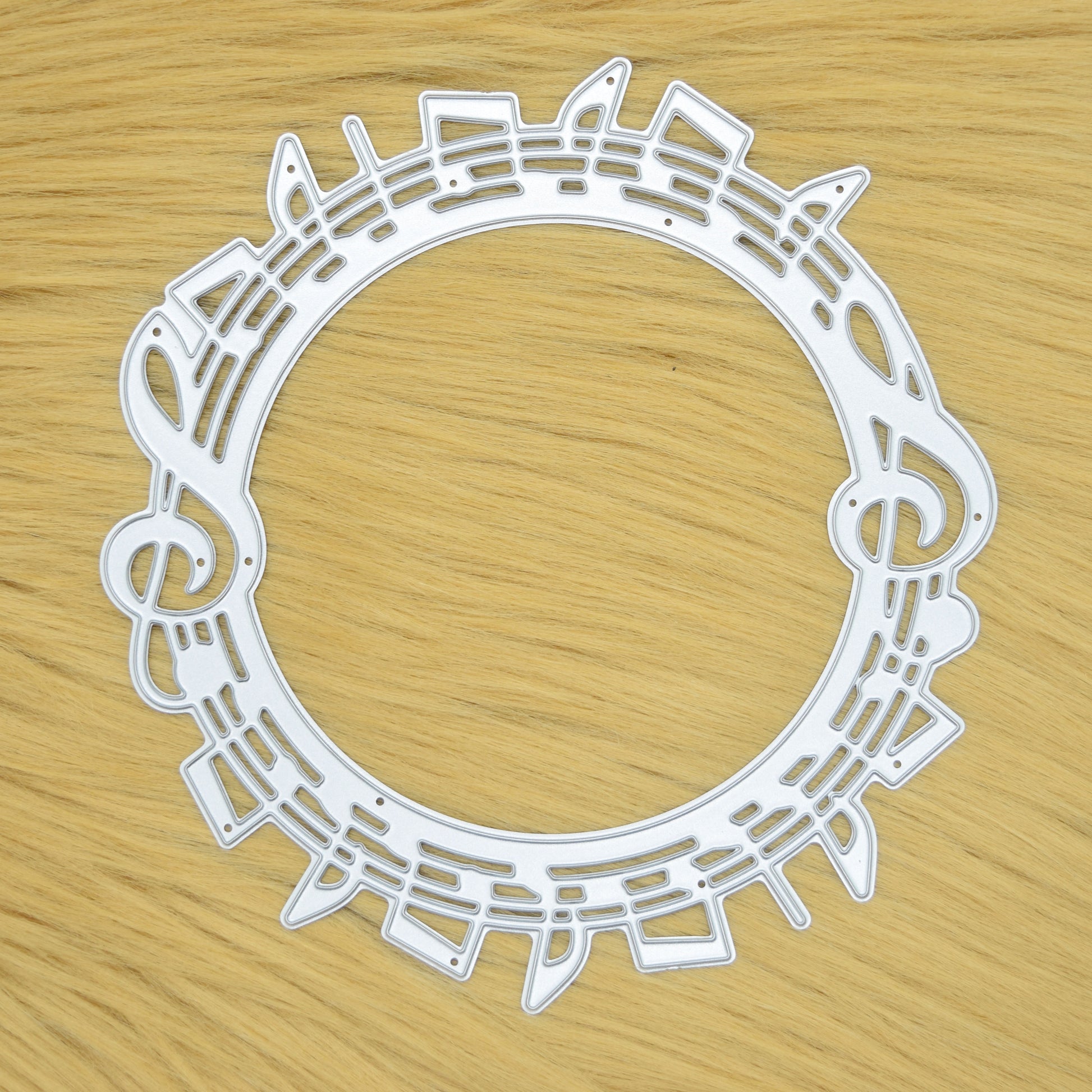 Music notes circle metal cutting die on faux fur background