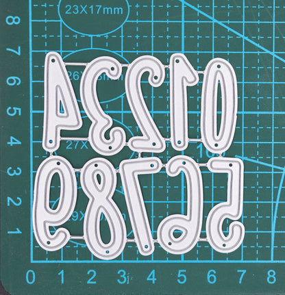 Number metal cutting dies set shown on measuring mat for size reference