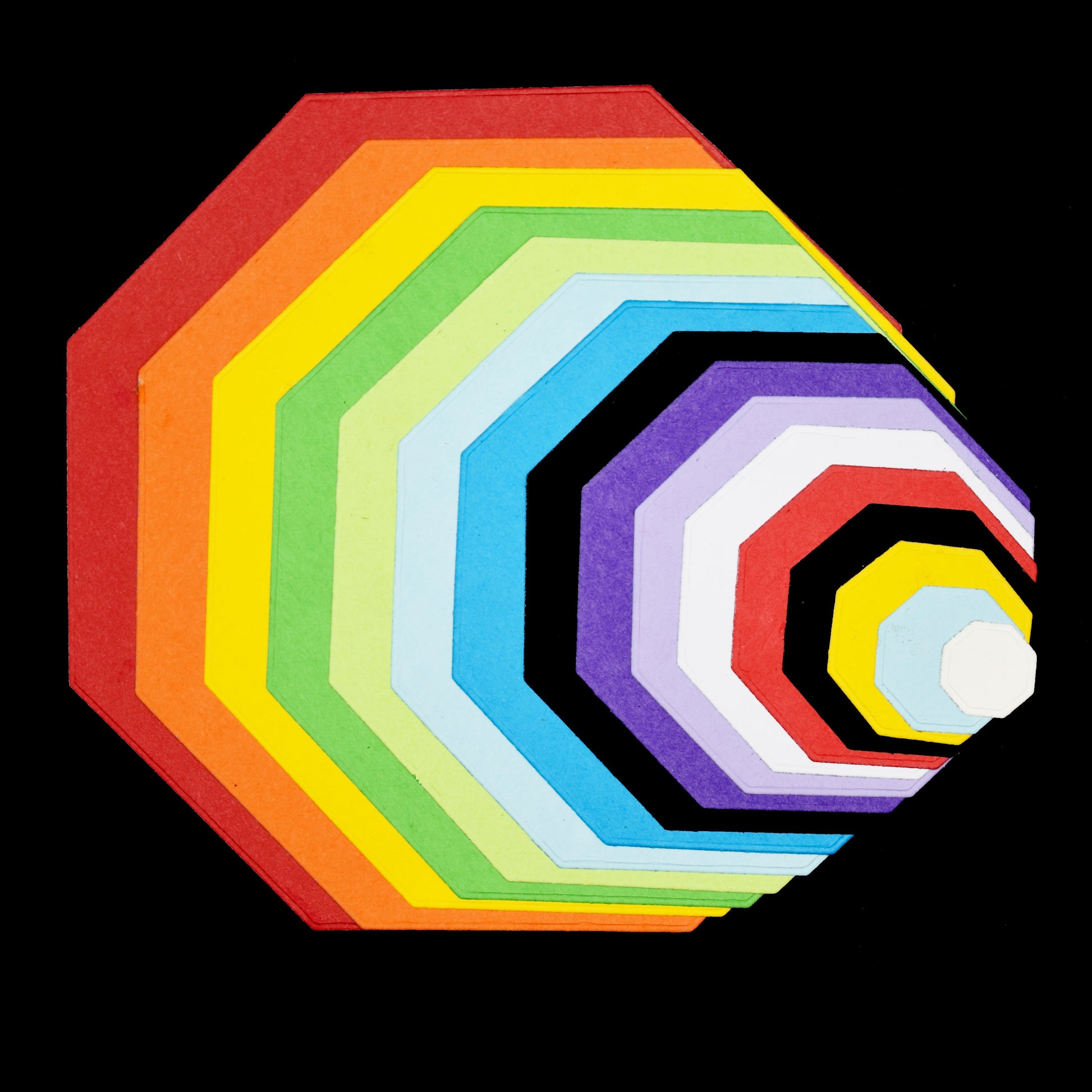 Layered octagon shapes cut from coloured card using nesting dies