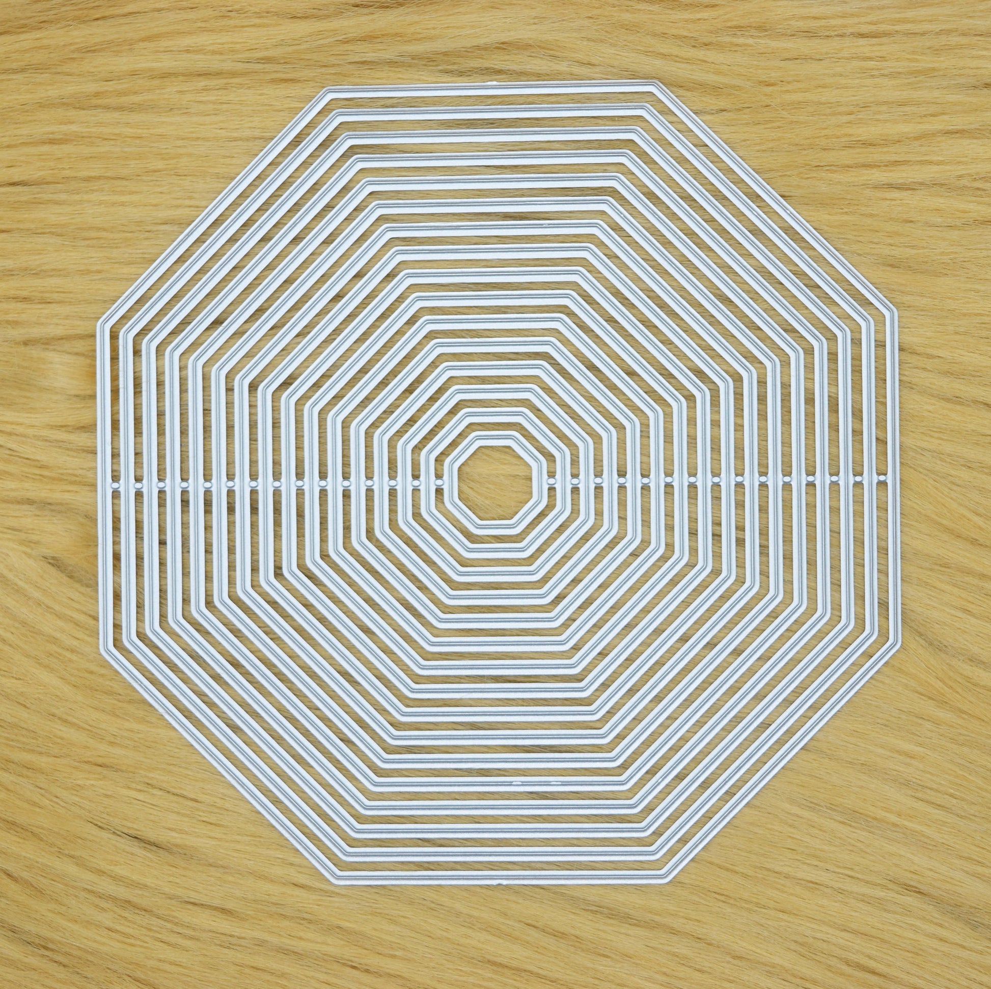 Octagon nesting cutting dies set on faux fur surface