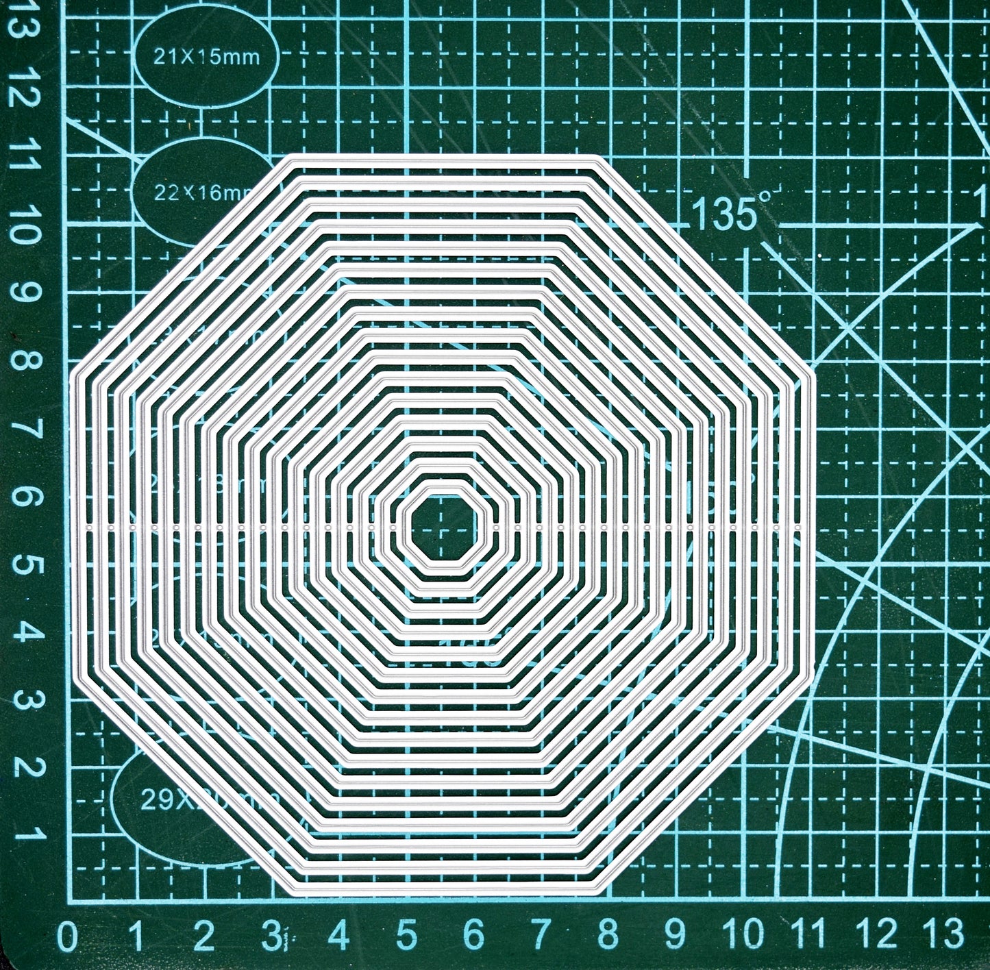 Octagon nesting dies on cutting mat showing measurements