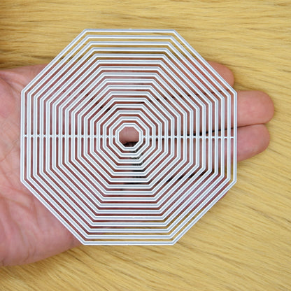 Octagon nesting dies held in hand showing size range