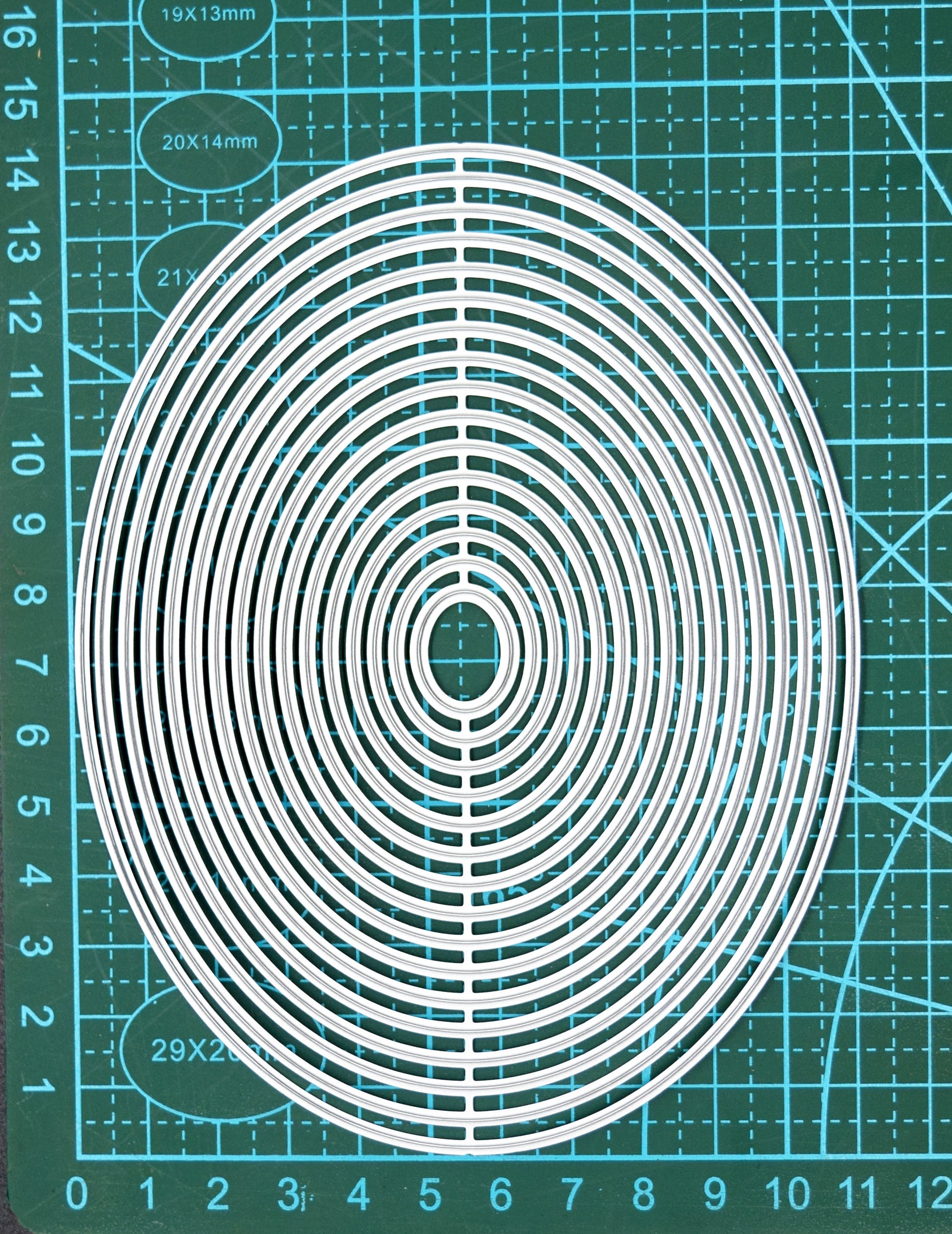Oval nesting dies set on cutting mat showing size and scale
