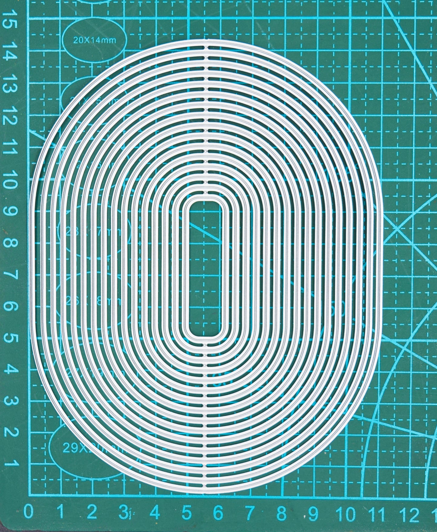 Large oval rectangle nesting cutting dies on measuring mat for sizing guide