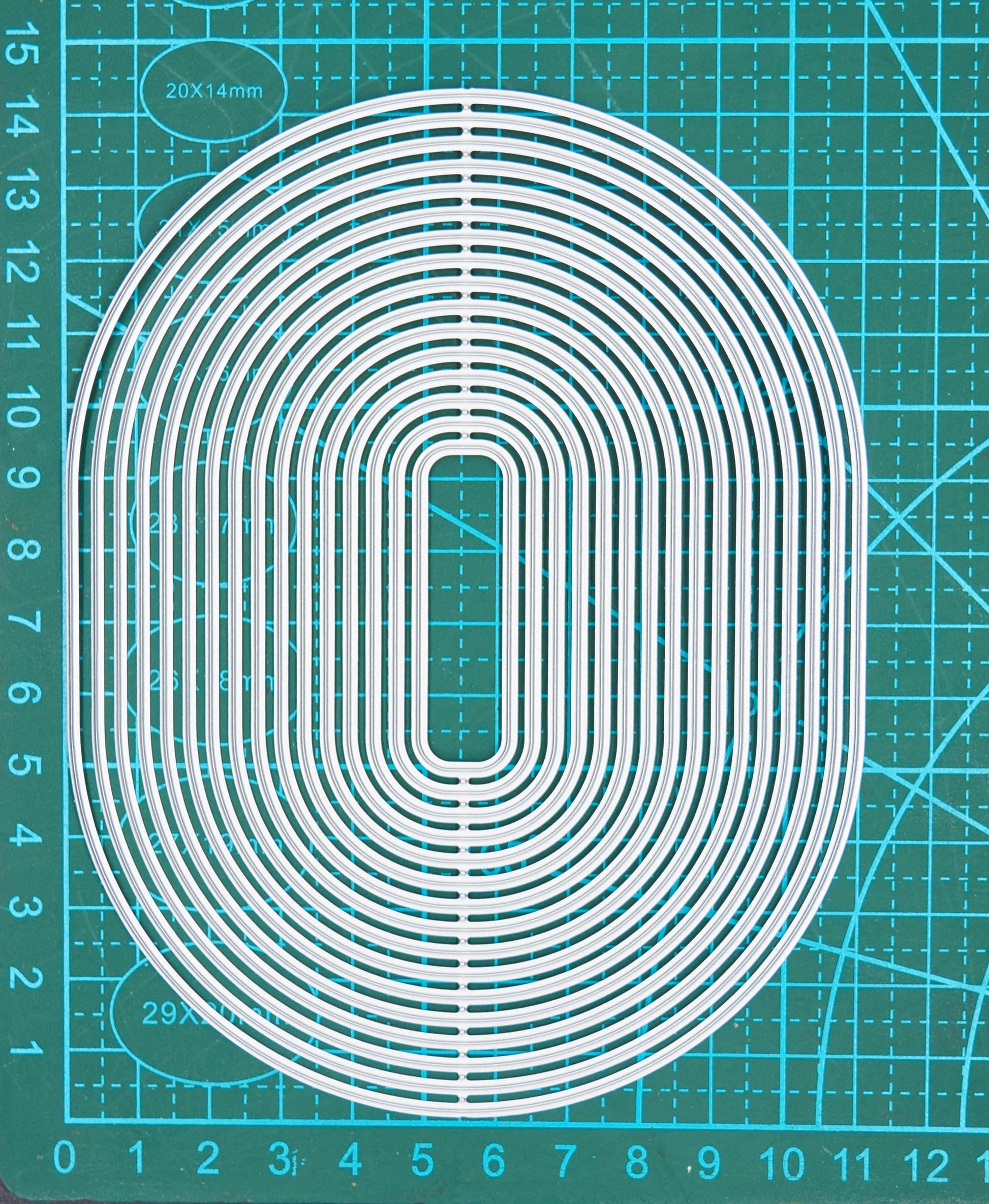 Large oval rectangle nesting cutting dies on measuring mat for sizing guide