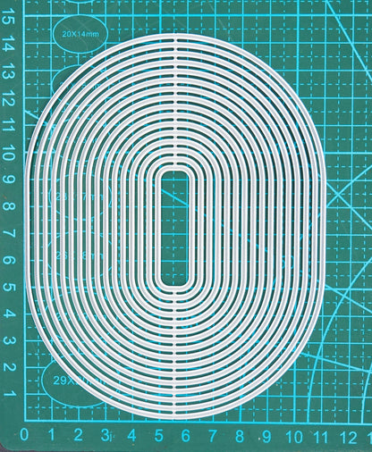 Large oval rectangle nesting cutting dies on measuring mat for sizing guide