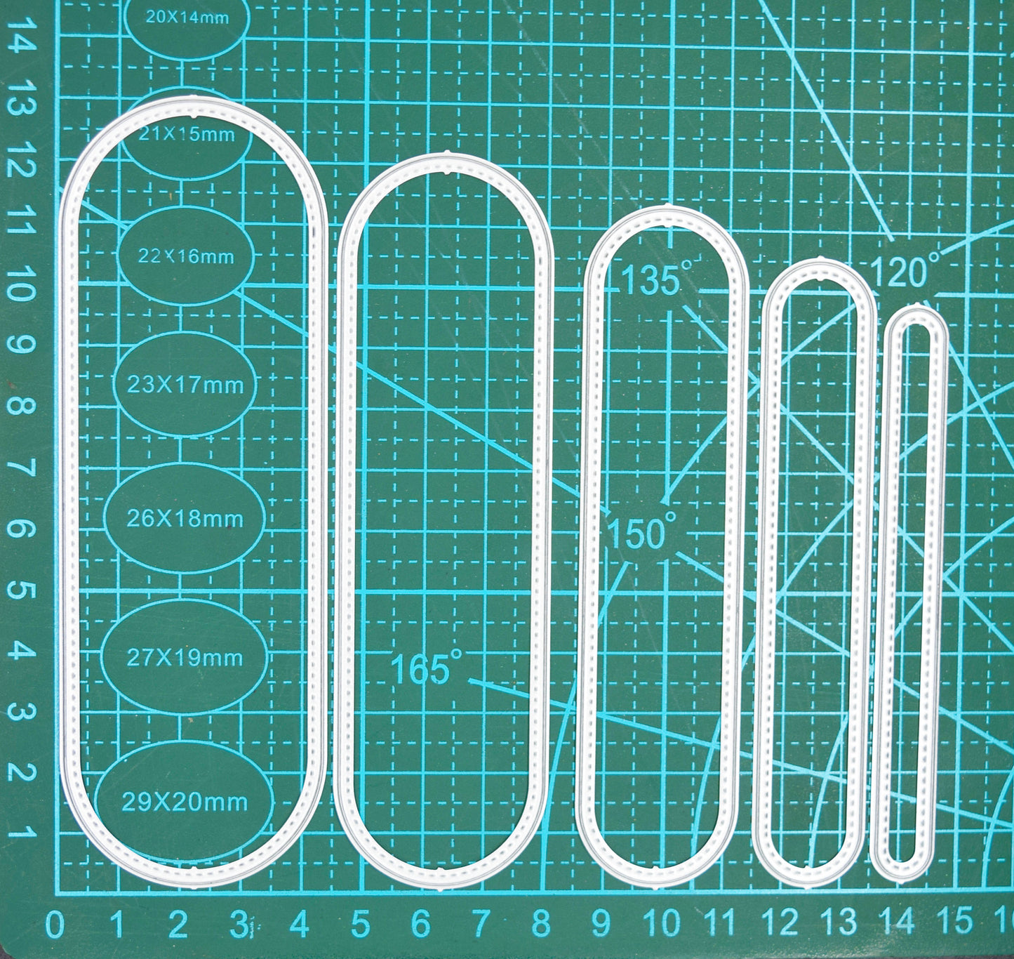 Slimline oval nesting metal cutting dies on cutting mat showing size progression and alignment