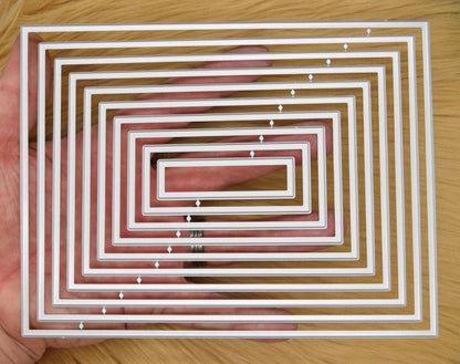 Plain rectangle nesting dies shown in hand for size reference and A6 card layering