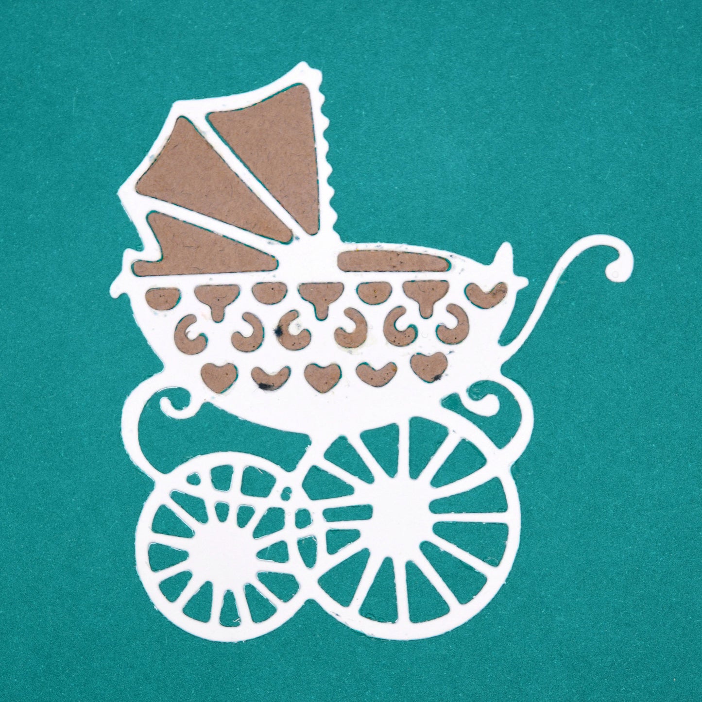 Finished baby pram die cut showing decorative carriage design for new baby card making