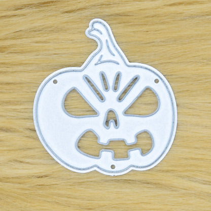 Halloween pumpkin metal cutting die displayed on a tan faux fur background for card making and papercraft.