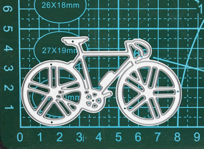 Racing bicycle metal cutting die displayed on a centimetre cutting mat to show scale for card making and papercraft.