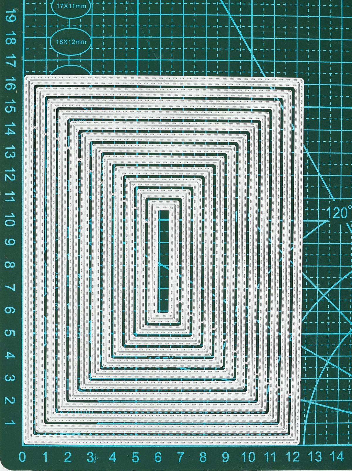 Twelve graduated rectangle double stitched metal cutting dies displayed on a centimetre cutting mat