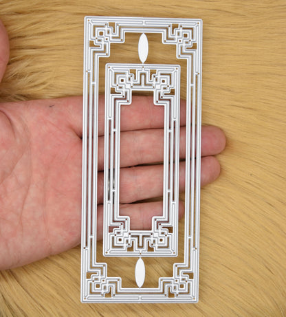 Art Deco rectangle metal cutting dies shown in hand for size reference