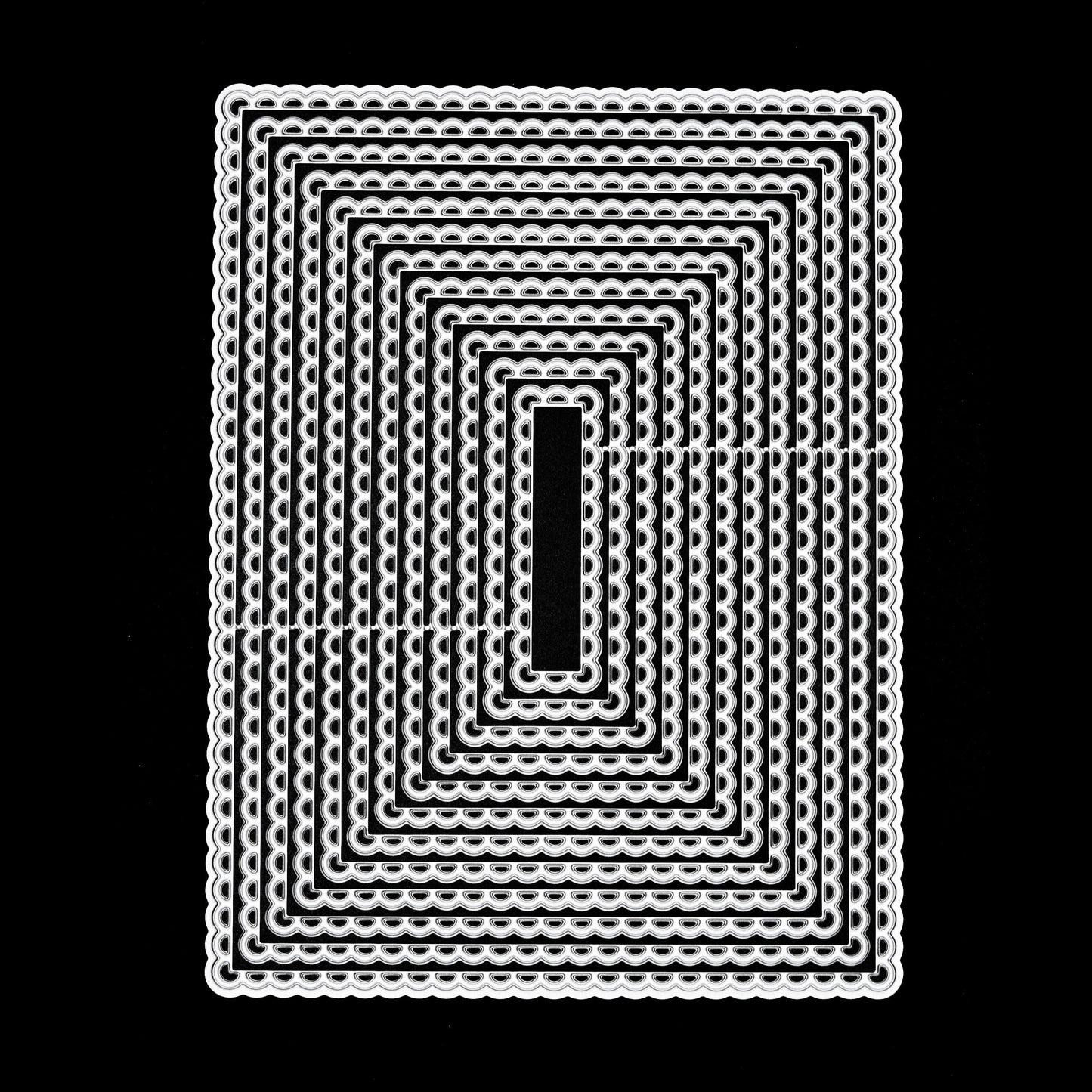 Large scalloped rectangle nesting metal cutting die set on black background showing decorative frilled edge detail
