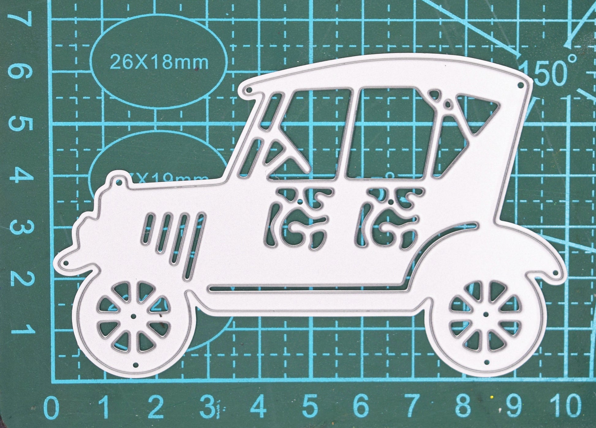 Vintage retro car metal cutting die on measuring mat for sizing guide