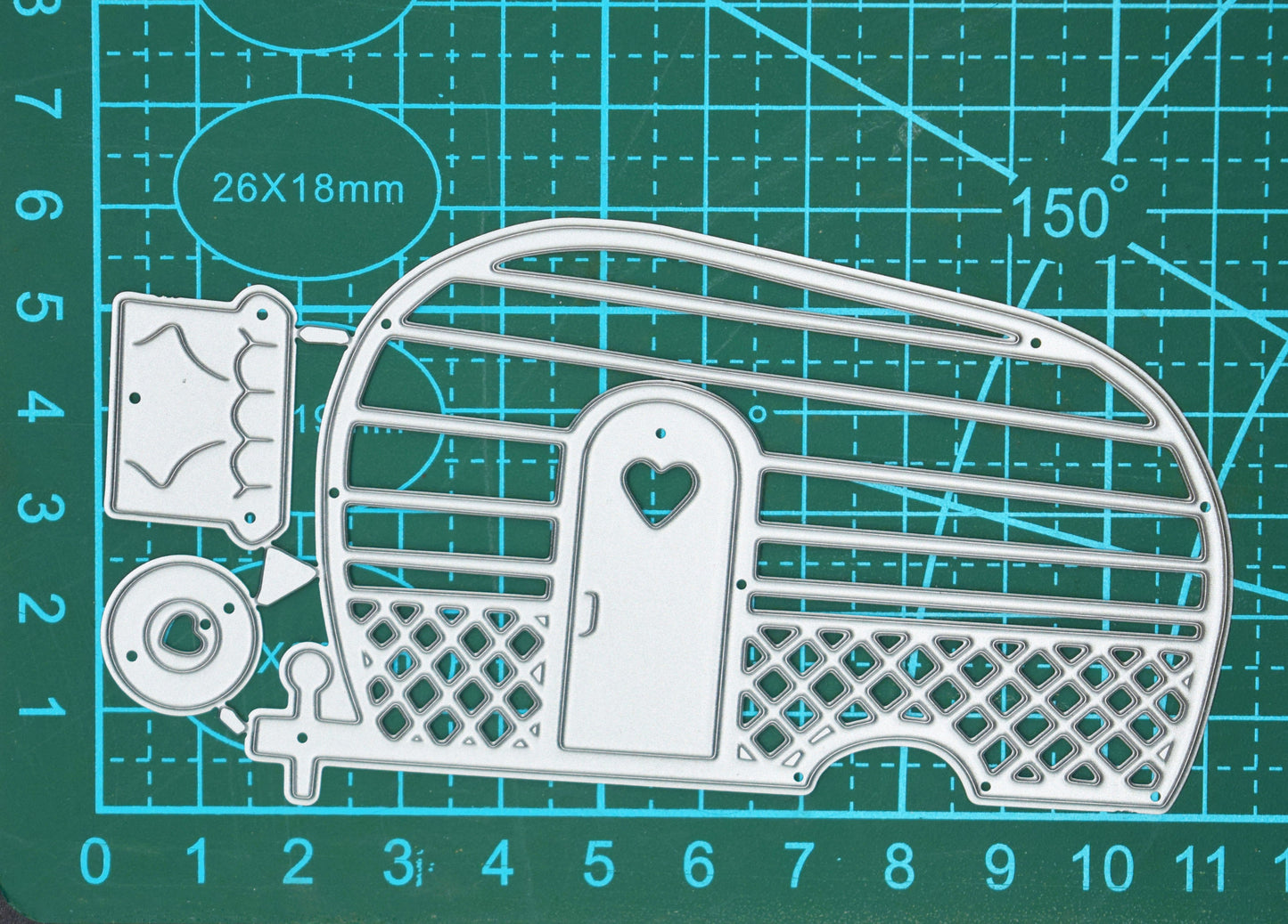 Retro caravan metal cutting die set shown on a cutting mat for size reference