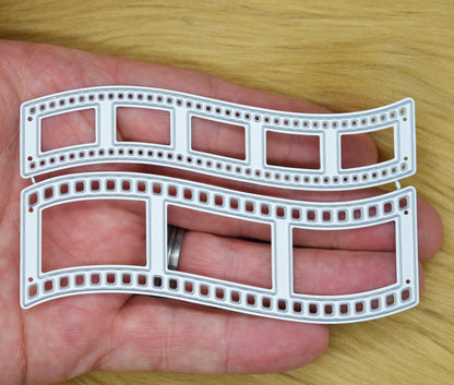 Retro film strip metal cutting dies shown in hand to demonstrate the size of the two-piece set