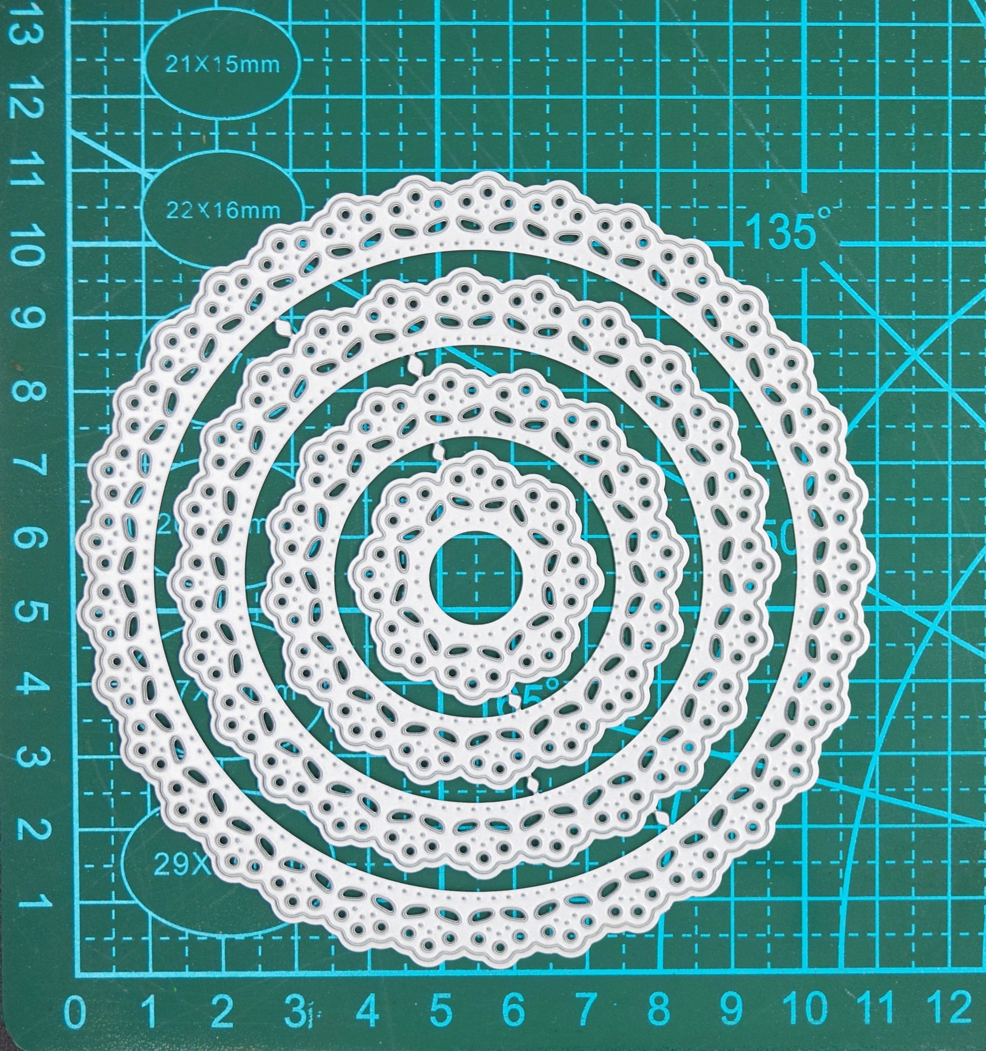 Full set of round lace nesting dies displayed on cutting mat for scale