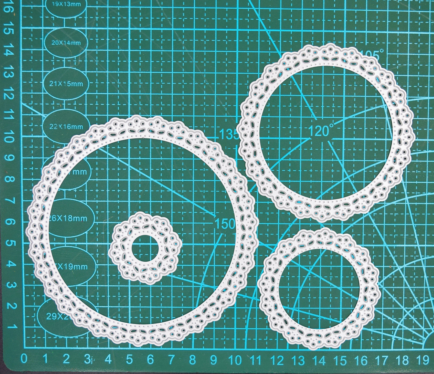Individual round lace nesting dies separated to show different sizes