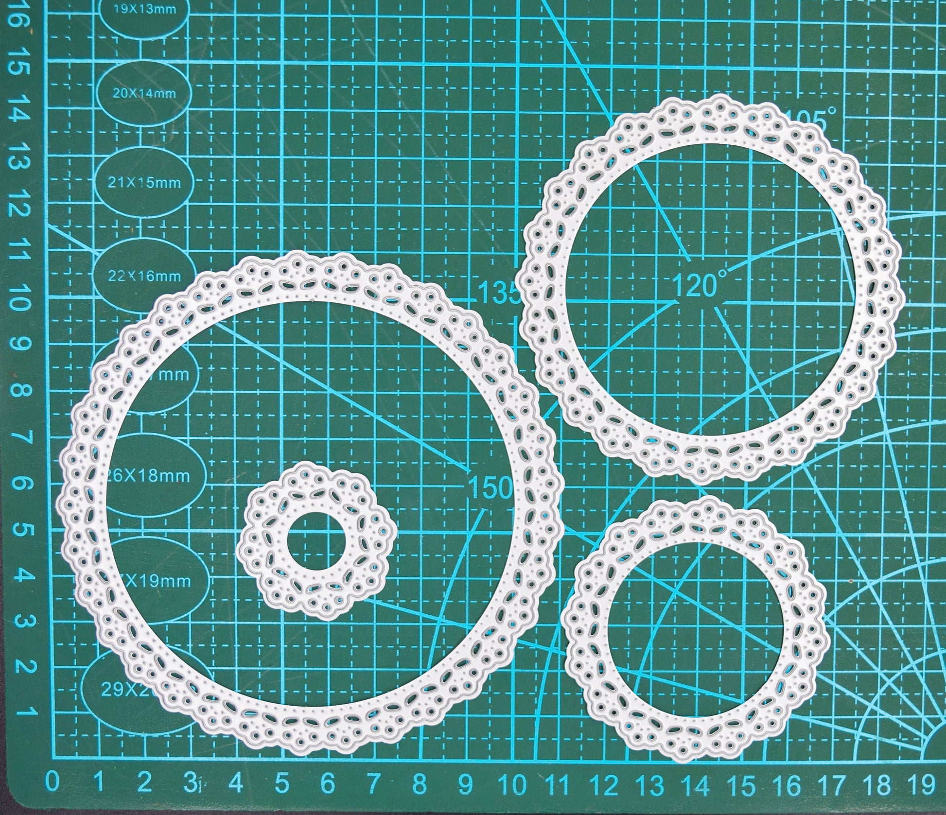 Individual round lace nesting dies separated to show different sizes