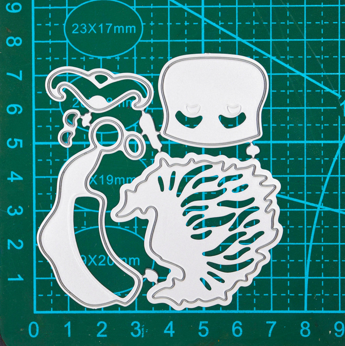 Santa face metal cutting die set on a centimetre cutting mat, showing the dimensions of the joined dies for papercraft.