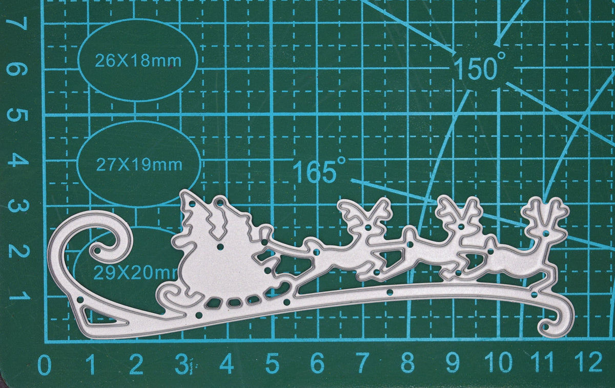 Santa sleigh and reindeer metal cutting die photographed on cutting mat for size reference