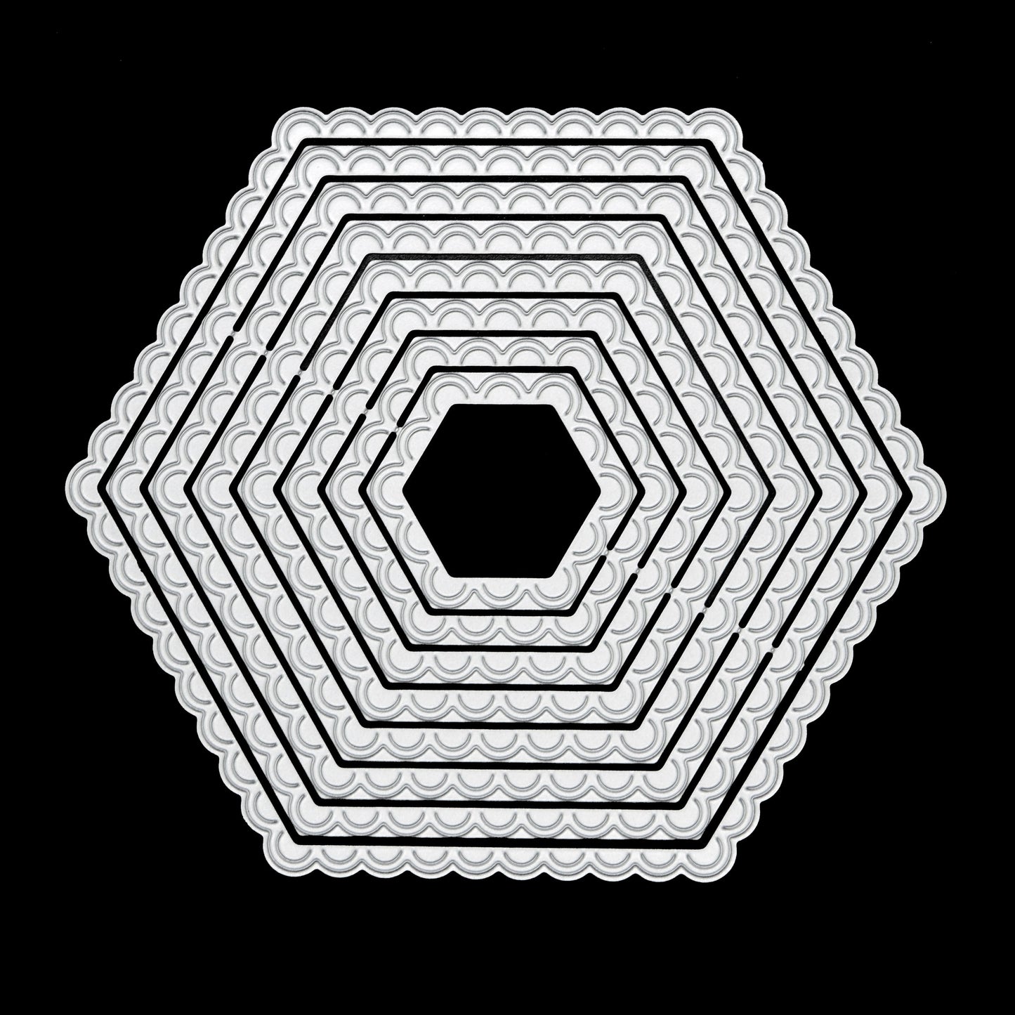 Graduated scalloped hexagon nesting metal cutting dies displayed together on a black background for card making and papercraft.