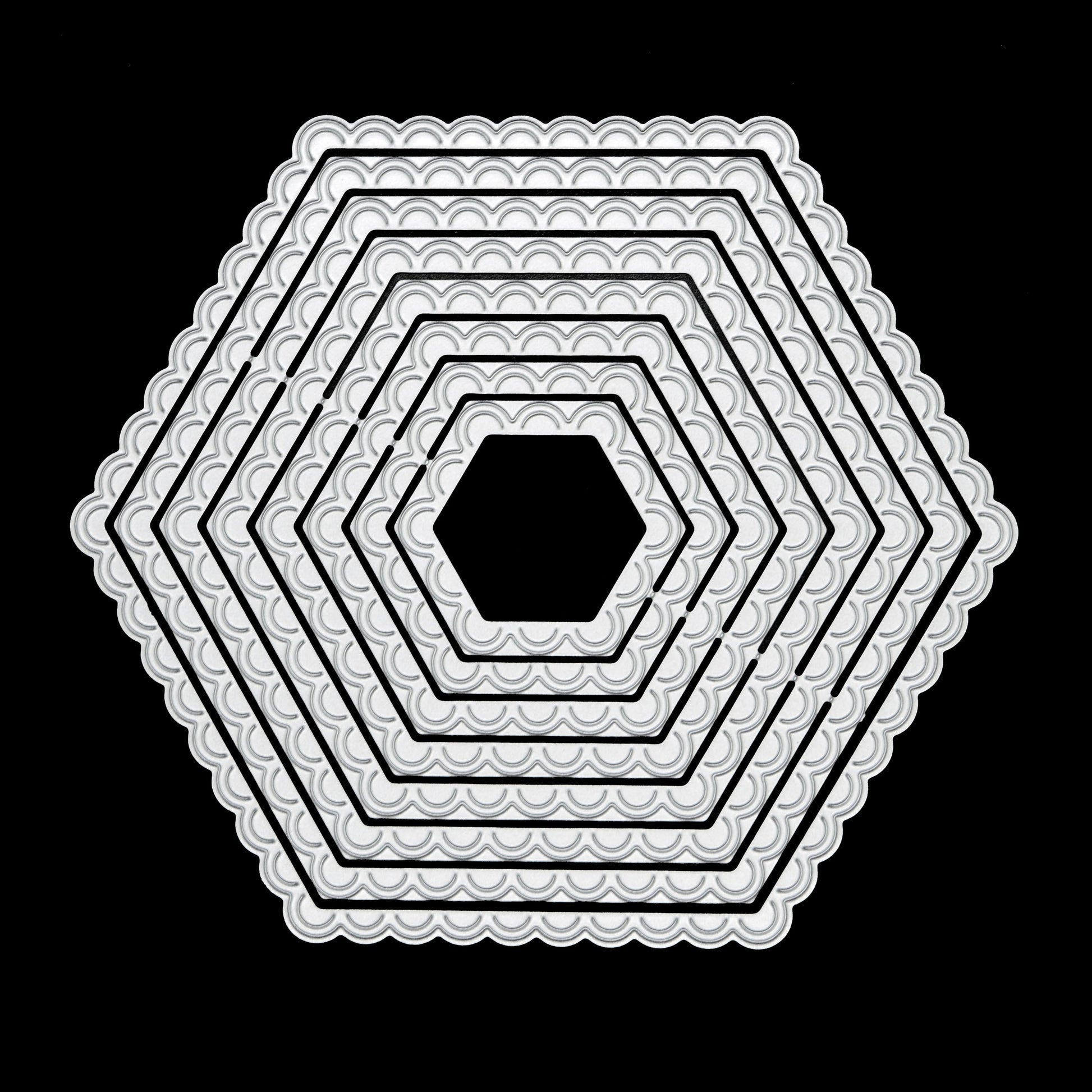 Graduated scalloped hexagon nesting metal cutting dies displayed together on a black background for card making and papercraft.