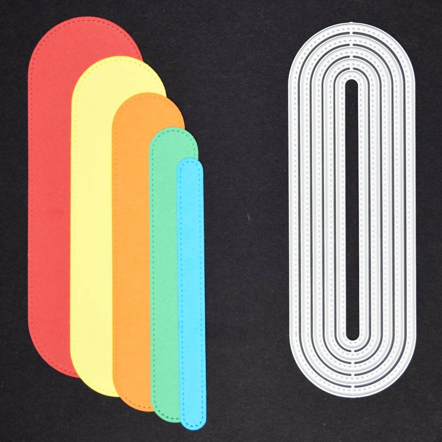 Slimline oval die cut shapes in coloured cardstock alongside matching metal cutting dies