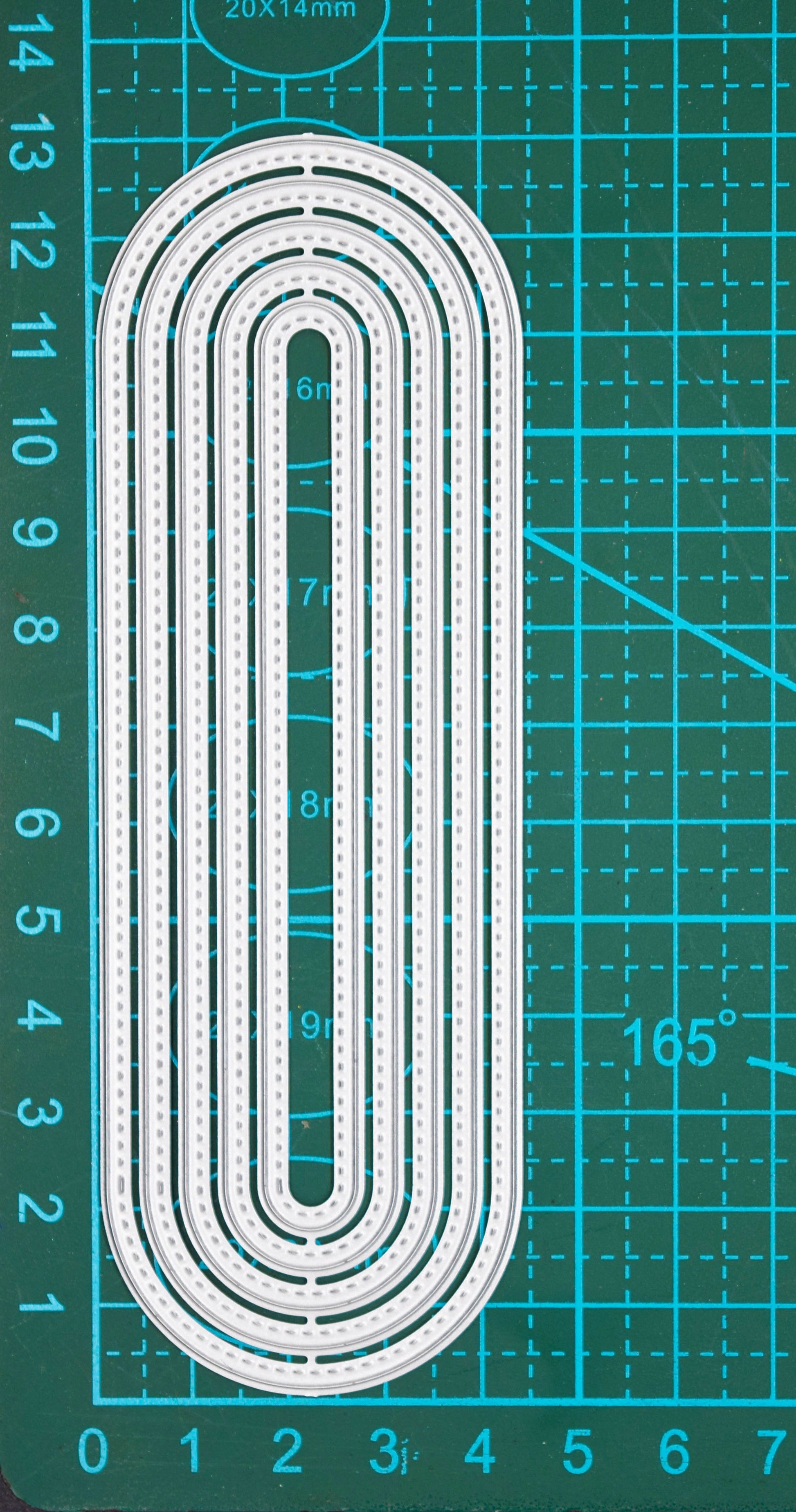 Slimline oval metal cutting dies on cutting mat showing graduated nesting sizes and stitched edges
