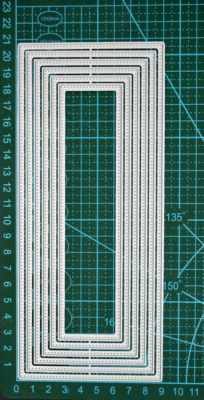 Large slimline rectangle nesting metal cutting die set displayed on a cutting mat to show the graduated sizes and dotted edge detail.