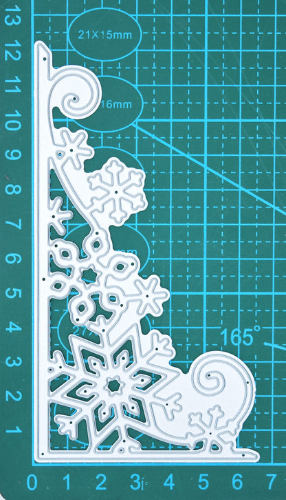 Large snowflake corner border metal cutting die shown on a centimetre cutting mat for size reference.
