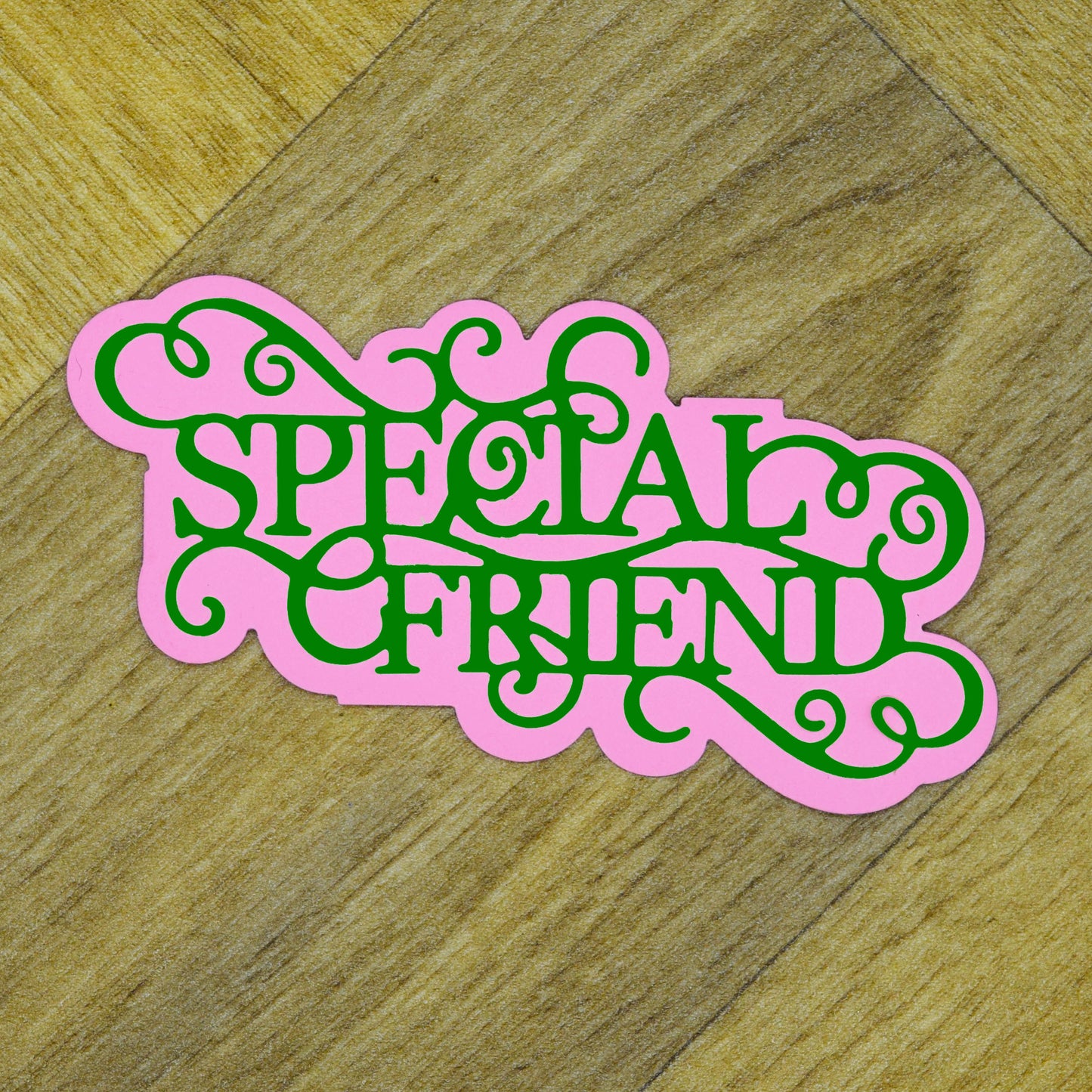 Pink and green layered Special Friend sentiment cut showing the decorative wording and coordinating background shape.