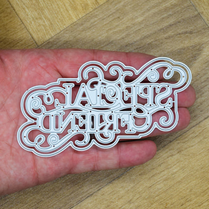 Detailed Special Friend layered sentiment metal cutting dies held in hand to show their size and intricate scrollwork.