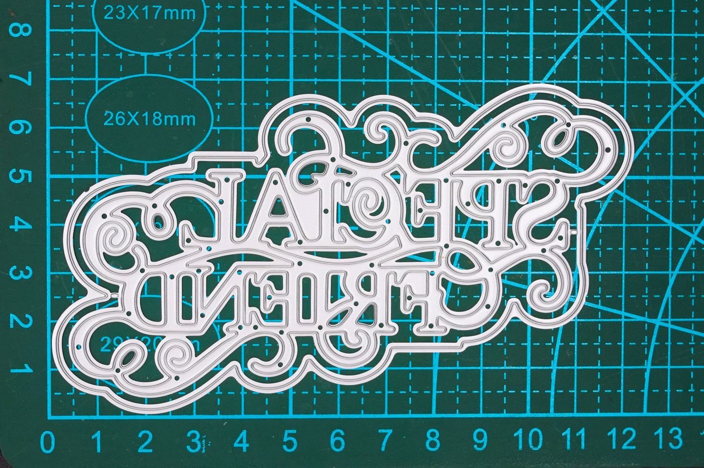 Ornate Special Friend sentiment metal cutting die displayed on a gridded cutting mat to show its detailed design.