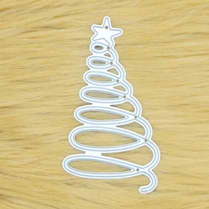 Spiral Christmas tree metal cutting die displayed on a tan faux fur background, showing the looping tree design and star topper.