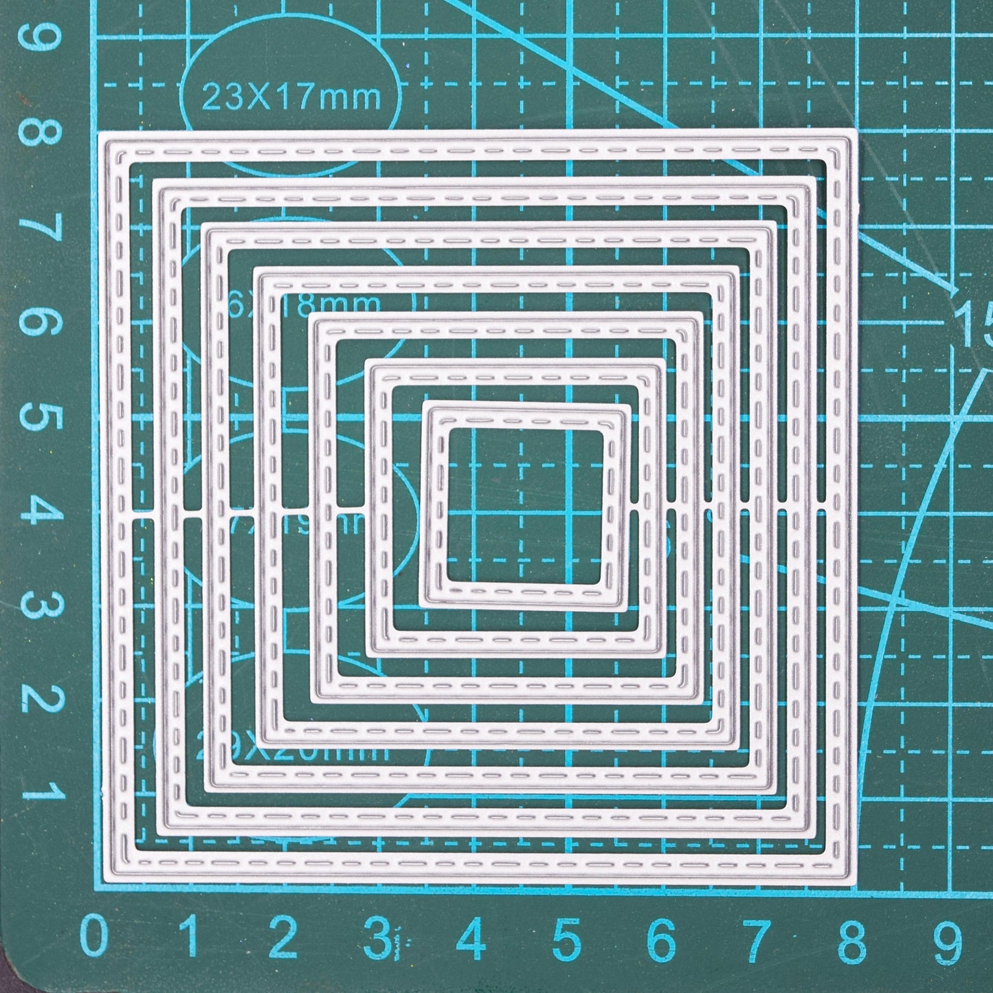 Square stitched nesting dies on measuring mat showing size