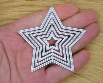 Stitched star nesting metal cutting dies shown in hand for scale
