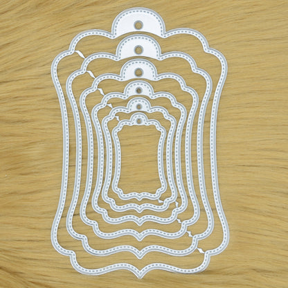 Elegant stitched tag nesting metal cutting dies set on wooden background