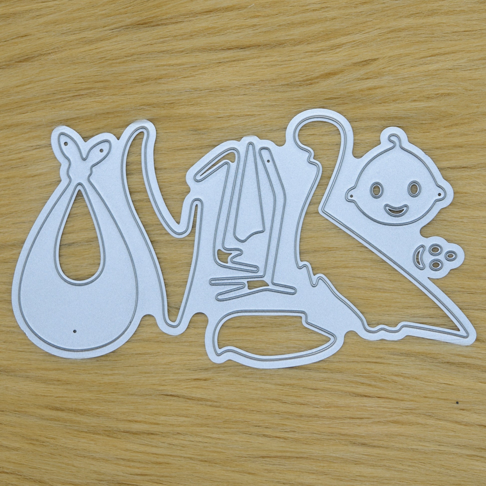 Stork and baby metal cutting die set on wooden background