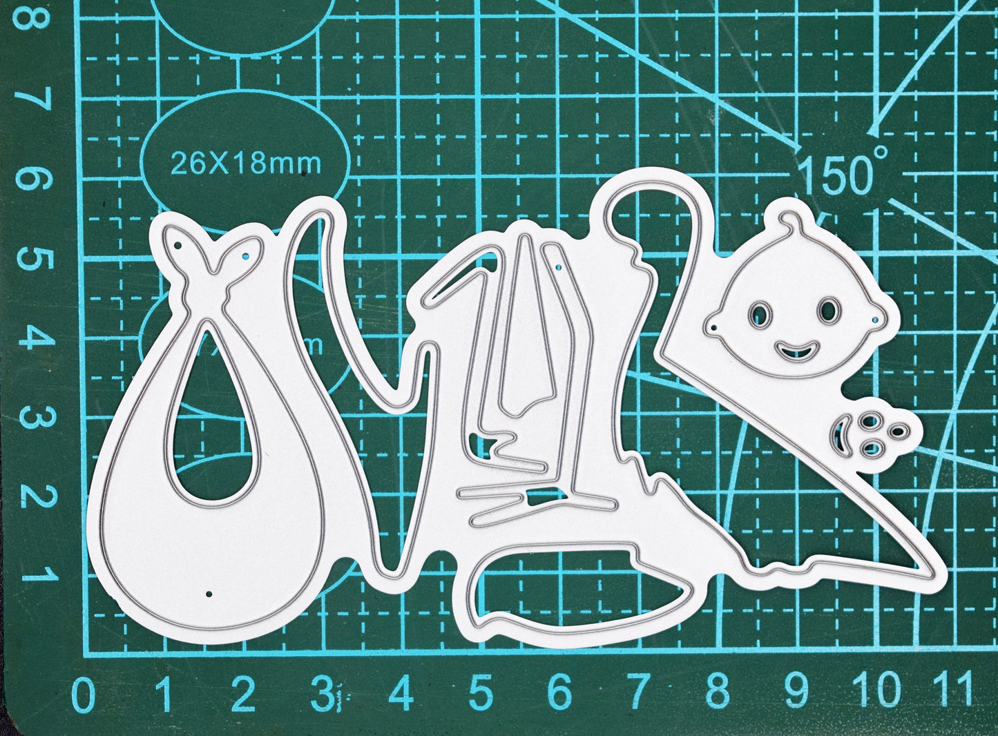 Stork and baby metal cutting dies on measuring mat showing size