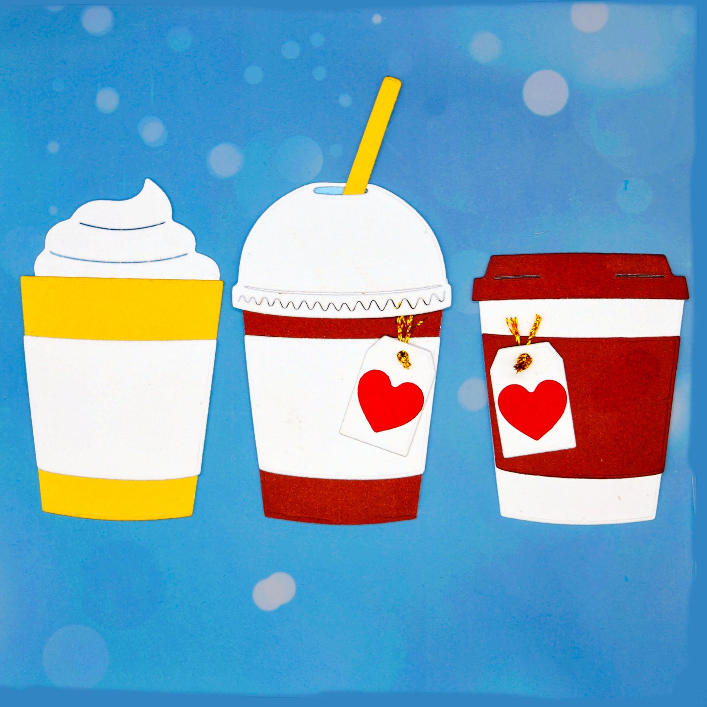 Takeaway coffee, latte and boba tea metal cutting dies set shown as three finished drink cup paper craft examples on a blue background