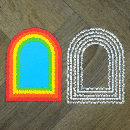 Layered Colourful arch example cuts displayed beside the matching torn edge arch metal cutting dies on a wood background.arch-shaped cardstock cuts 