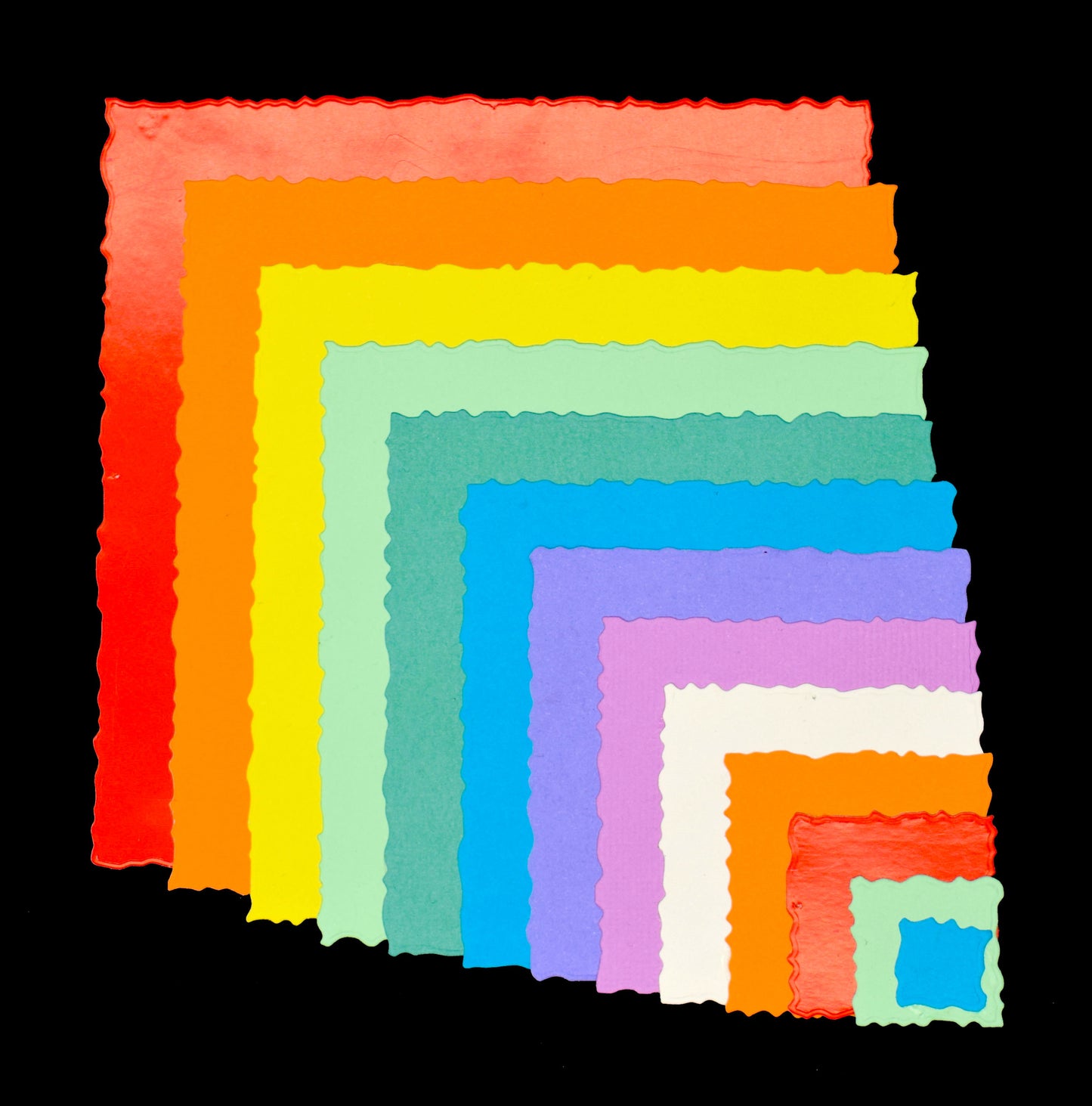 Thirteen colourful graduated square die cuts with irregular torn-style edges displayed on a black background