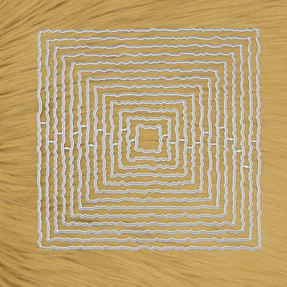 Set of thirteen torn edge square nesting metal cutting dies arranged on a faux fur  background